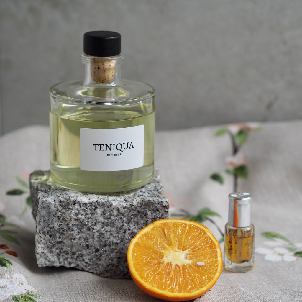 Diffuser bottle with citrus and bottle of oud