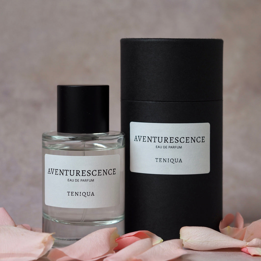 Two Aventurescence Teniqua perfume bottles on a neutral background with pink petals.