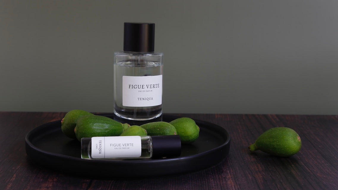 Bottles of Figue Verte edp with green figs on black plate.